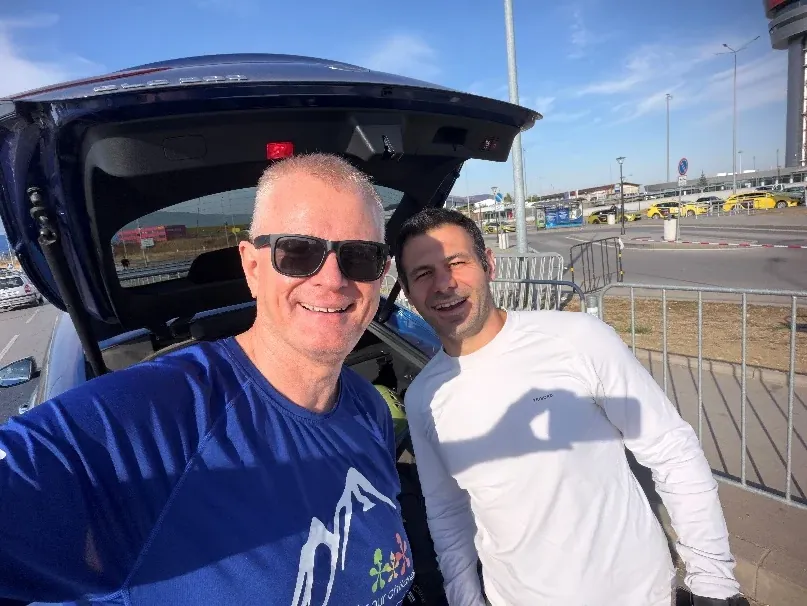 Two climbers in Bulgarian 56 Peaks shirts setting off for Mount Olympus