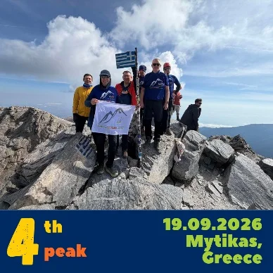 The team at the summit of Mytikas holding a banner: 4th peak, 19.09.2026