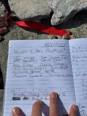 Signing the summit logbook on Mytikas