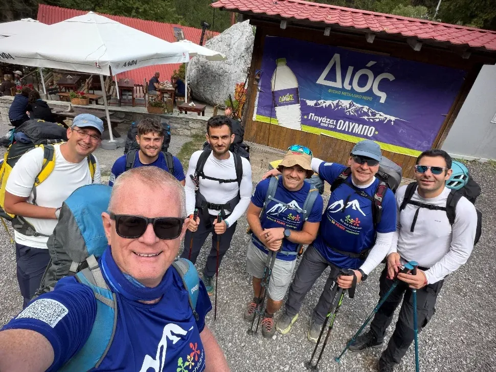 The team with backpacks and trekking poles at the Olympus trailhead