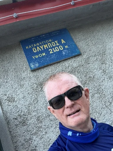 Selfie beside the refuge sign on Olympus at 2,100 m