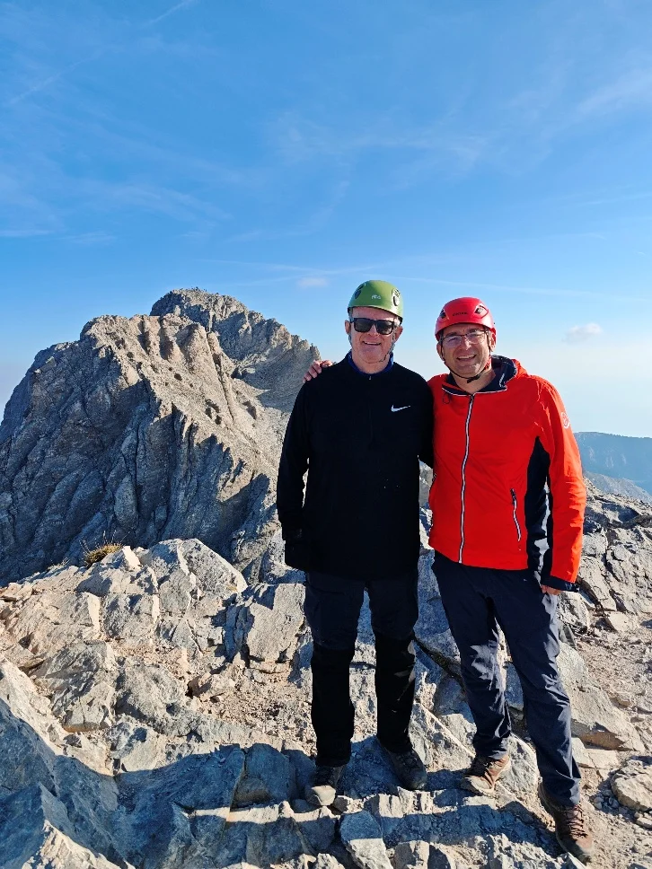 Two climbers on the rocky slopes below Mytikas